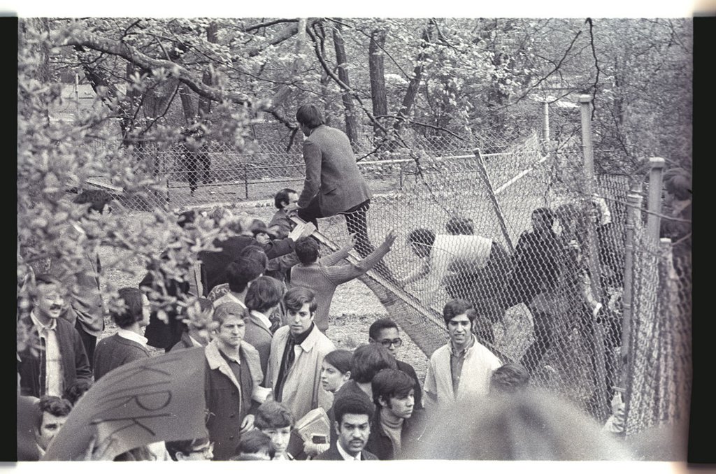 Image of Protestors tearing down protective fencing